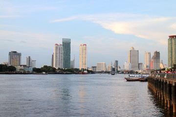 Fototapeta na wymiar Bangkok pier riverside Thailand, view high building tower, condominium and hotel.