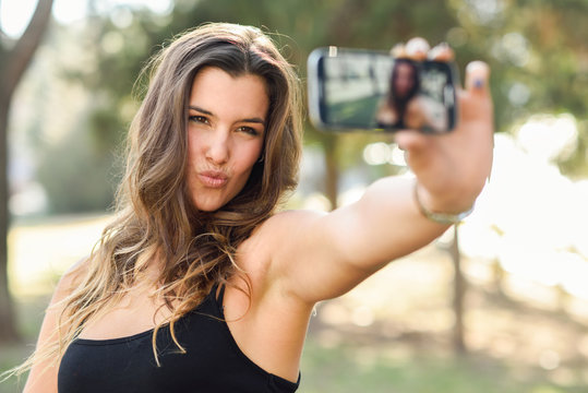 Beautiful young woman selfie in the park