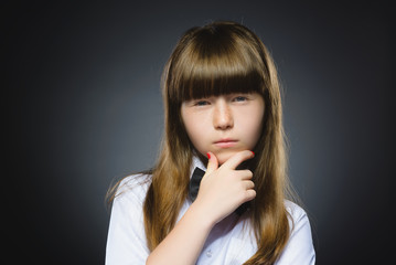 Closeup Thoughtful girl with Hand at head isolated on Gray