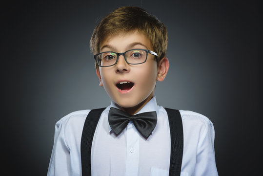 Closeup Portrait of happy boy going surprise isolated on gray background