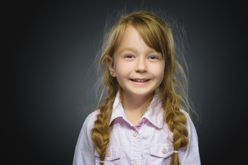Happy girl. Closeup Portrait handsome child smiling isolated on grey