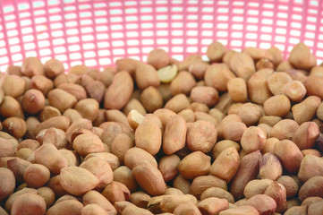 Peanuts / Close up dry peanuts in the plastic basket.