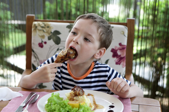 Child Eating Chicken Leg