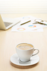 Office workplace with with laptop and coffee