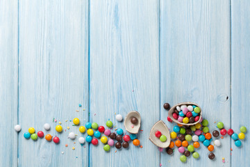 Colorful candies on wooden table