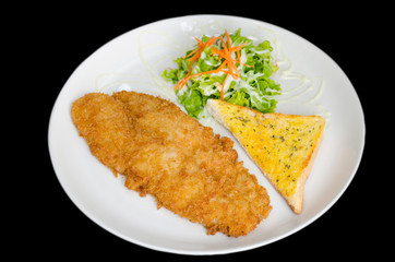 Breaded fried fish with bread and Vegetable isolated on the blac