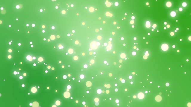 Sparkly gold and silver light particles moving across a green gradient background