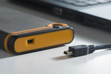 Orange external hard disk with microi usb cable