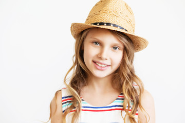 portrait of a lovely little girl with straw hat against a white