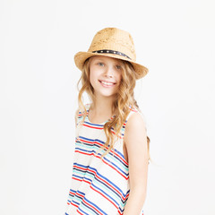Lovely little girl with straw hat against a white background.