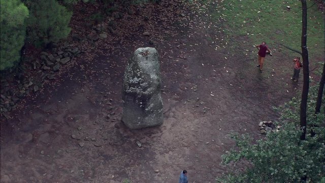 Carnac Prehistory Stones, Tight On Large Detailed Stone, With Tourists, Pulling Behind Trees