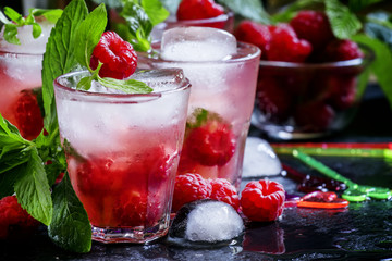 Raspberry mojito alcoholic cocktail with berries, lime, mint and