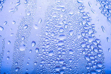Drops of water on a glass background. Selective focus. Toned