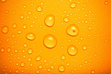 Drops of water on a color background. Orange. Toned
