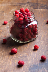 Lots of fresh bright red raspberries. Selective focus. Shallow d