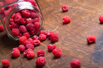 Lots of fresh bright red raspberries. Selective focus. Shallow d