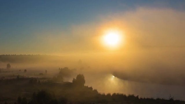 timelapse of sun rises above the fog and the river summer morning