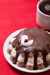 Homemade cake with bird decor on red tablecloth for background.