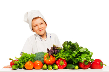 Happy kid preparing healthy vegetables meal