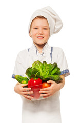 Young smiling cook with bowl of fresh vegetables