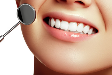 Healthy woman teeth and a dentist mouth mirror. Dental hygiene