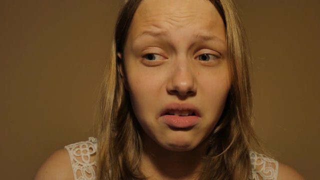 Teen girl with something disgusting on her hands. 4K UHD.