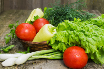 Tomatoes, yellow pepper, dill, parsley and shallots in a basket 