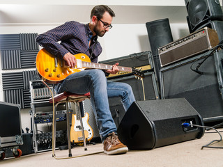 Fototapeta na wymiar Playing electric guitar in a studio