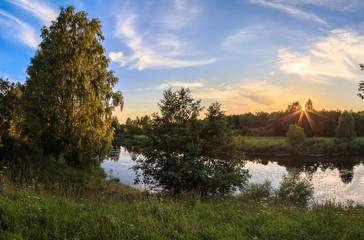 Sunset over a small Russian river, summer evening