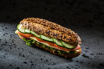Whole wheat sandwich with cheese, tomato, lettuce and cucumber.