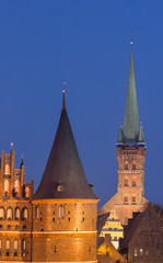 Fototapeta premium Holstein gate and Petri church by night in Lubeck