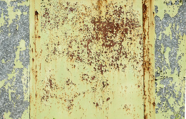 Weathered grunge tin surface with old peeling paint as background