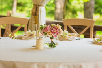 flower composition and candles in the restaurant. Wedding dinner
