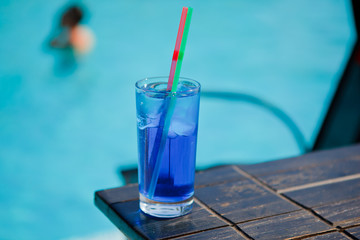 blue cocktail near pool