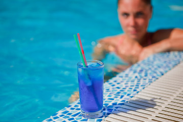 girl with cocktail near pool
