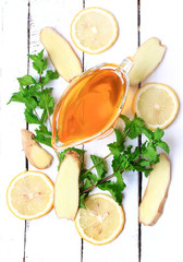 ginger honey lemon mint on a white wooden background ingredient