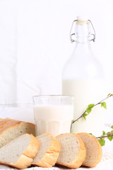 milk and bread on a white lace background bio organic product fresh pastries healthy lifestyle