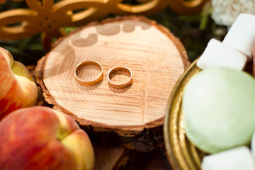 Beautiful engagement ring lie on wooden stand