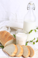 milk and bread on a white lace background bio organic product fresh pastries healthy lifestyle