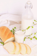 milk and bread on a white lace background bio organic product fresh pastries healthy lifestyle