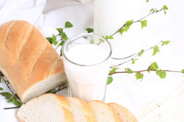 milk and bread on a white lace background bio organic product fresh pastries healthy lifestyle