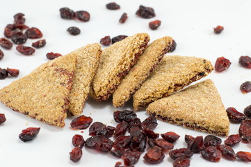 Integral triangle cookies with raisins on white