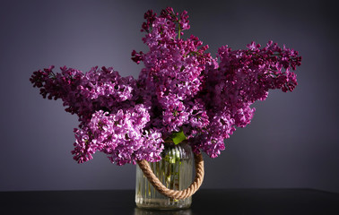 Bouquet of purple lilac flowers on dark background