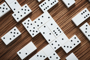 Heap of dominoes on wooden background