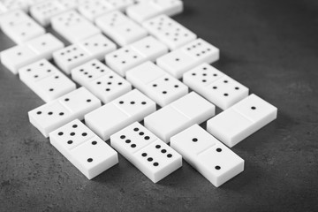 Heap of dominoes on grey background