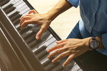 Female hands playing piano