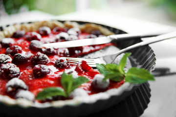 Sliced cherry pie in baking dish, close up