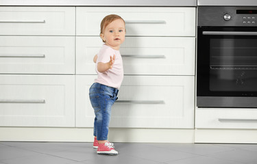 Little child playing with drawer