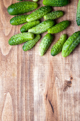 The image of fresh cucumber on a wooden table