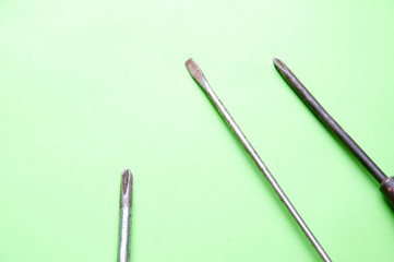 The image of screwdrivers on a green background